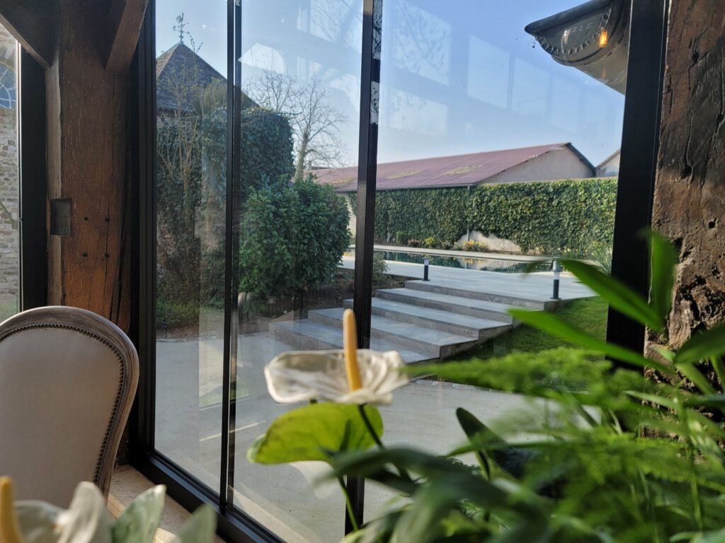 Vue de la piscine de l'intérieur de la salle Verrière